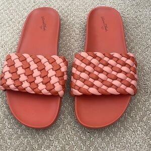 Orange target slip on sandals